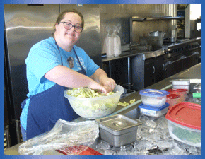 VTC individual making salad in The A Street Cafe kitchen
