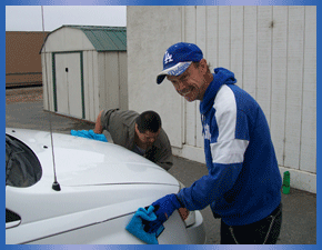 two VTC individuals washing a car